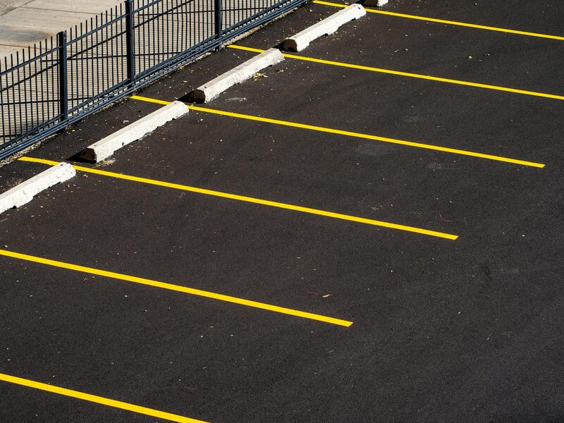 Worn parking-lot stripes, faded paint and fading lane markings