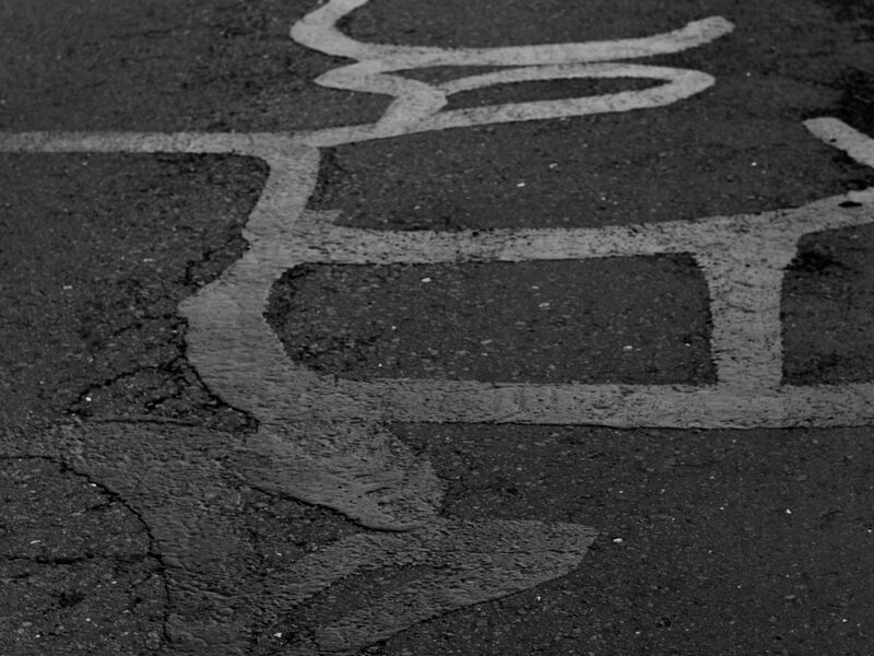 Hot-pour crack sealant being applied to asphalt cracks