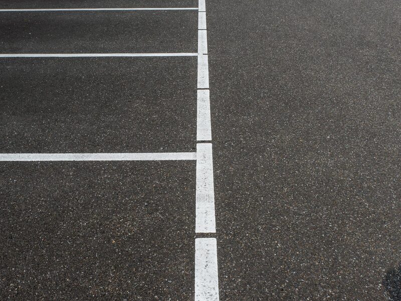 Bright fresh parking lot line paint application