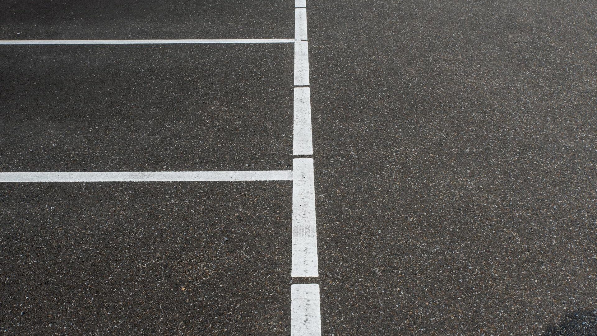 Bright fresh parking lot line paint application